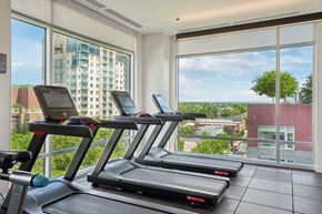 Denver apartment for rent - A gym with treadmills and a view of the city.