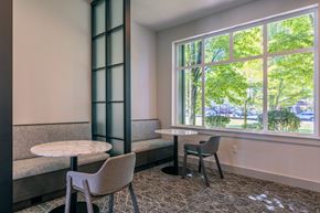 Mukilteo apartment for rent - a room with tables and chairs and a large window