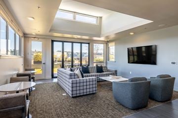 Seattle apartment for rent - A modern living room with a grey sofa and a flat screen TV.