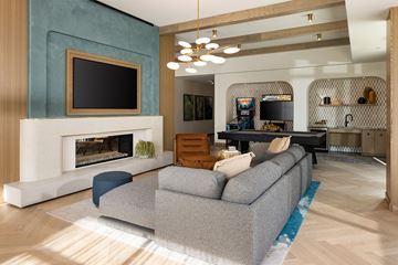 Vista apartment for rent - A modern living room with a grey sofa and a fireplace.