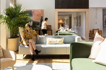 San Diego apartment for rent - a woman sitting on a couch in a living room