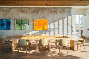 Seattle apartment for rent - a dining room with a long table and chairs and artwork on the wall