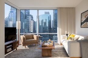 Seattle apartment for rent - a living room with a city view and a couch and a table