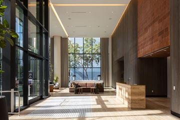 San Diego apartment for rent - A modern office lobby with a view of the trees outside.