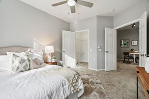 Hillsboro townhouse for rent - A bedroom with a large bed and a ceiling fan.