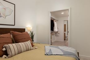 Huntington Beach apartment for rent - A bedroom with a bed, pillows, a lamp, and a painting on the wall.