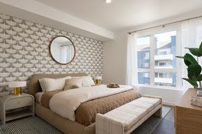 Long Beach apartment for rent - A bedroom with a large bed and a round mirror on the wall.