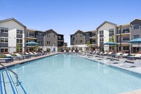 Denver apartment for rent - A large swimming pool in front of apartment buildings.