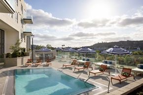 San Diego apartment for rent - a swimming pool with chaise lounge chairs and umbrellas