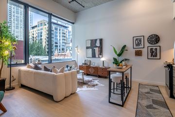 Seattle apartment for rent - A living room with a white couch and a large window.