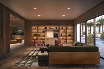 Los Angeles apartment for rent - A modern living room with a green couch and a wooden coffee table.
