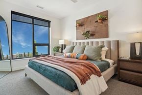 Denver apartment for rent - a bedroom with a bed and a large window