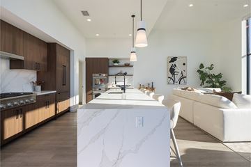 San Diego apartment for rent - A modern kitchen with a white marble island and wooden cabinets.