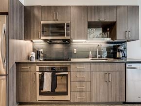 Seattle apartment for rent - A modern kitchen with wooden cabinets and stainless steel appliances.
