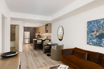 San Diego apartment for rent - A living room with a brown couch and a painting on the wall.