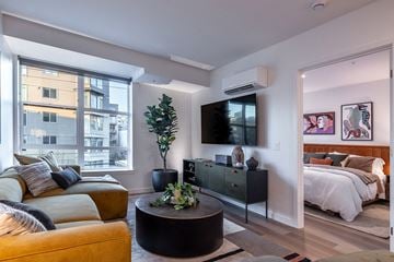 Seattle apartment for rent - A living room with a yellow couch and a black coffee table.