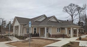 Charlotte apartment for rent - a house with a porch and a sidewalk in front of it