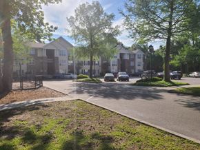 North Charleston apartment for rent - an apartment building with cars parked in a parking lot