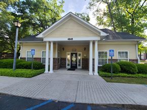 North Charleston apartment for rent - the front entrance of a cream colored building with pillars and a porch