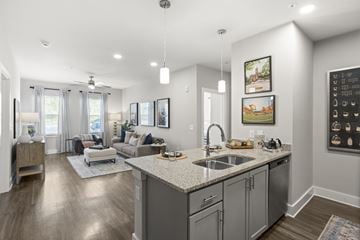 Pendleton apartment for rent - A modern kitchen with a large island and a living area with a couch and chairs.