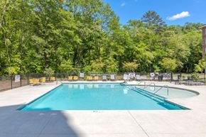Seneca apartment for rent - a swimming pool with a fence around it and trees in the background