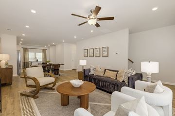 Mauldin townhouse for rent - A living room with a brown chair and a white couch.