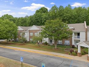 Travelers Rest apartment for rent - A view of a road with a building and a sign.