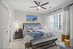 Pendleton apartment for rent - A bedroom with a bed, nightstand, and a ceiling fan.