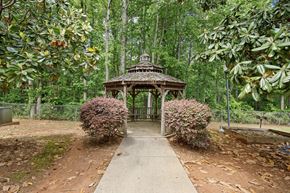 Travelers Rest apartment for rent - A gazebo is surrounded by green trees and shrubbery.
