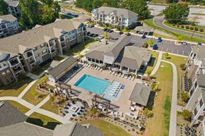 Pendleton apartment for rent - An aerial view of apartment buildings with a pool in the foreground.
