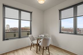 Spartanburg apartment for rent - A room with a balcony at Aug Smith on Main, with a table and chairs.