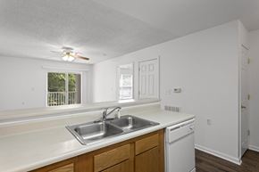 Travelers Rest apartment for rent - A kitchen with white cabinets and a window.