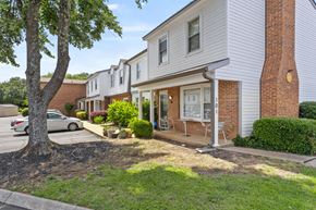Greenville apartment for rent - A tree is in front of a house.