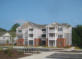 Winston Salem apartment for rent - A large apartment complex with a parking lot in front.
