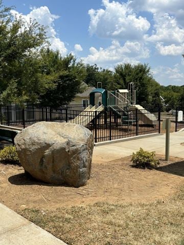 Charlotte apartment for rent - A large rock sits in the middle of a playground.