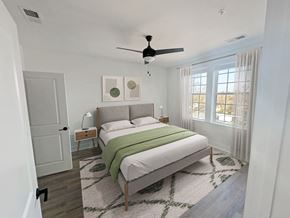 Greenville apartment for rent - Gordon Street Lofts Bedroom with bed, rug, dresser and floor-to-ceiling curtains.