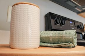 Spartanburg apartment for rent - A white textured container sits on a counter next to a green towel.