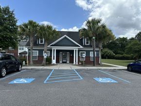 North Charleston apartment for rent - an empty parking lot in front of a building with palm trees