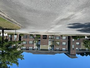Goose Greek apartment for rent - a reflection of an apartment building in a pool of water