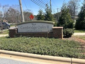 Kings Mountain apartment for rent - A sign for Cambridge Oaks II Apartments is displayed in front of a hedge.