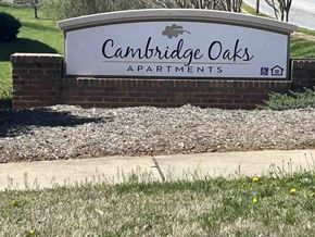 Kings Mountain apartment for rent - A sign for Cambridge Oaks Apartments is displayed in front of a grassy area.