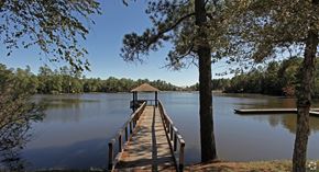 Columbia apartment for rent - A wooden pier extends into a calm lake surrounded by trees.
