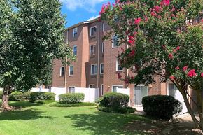 Columbia apartment for rent - A red brick building with a green lawn in front.