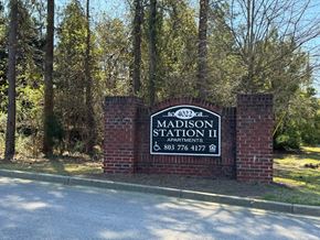 Columbia apartment for rent - A sign for Madison Station II Apartments stands in front of a wooded area.