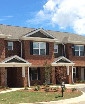 Orangeburg apartment for rent - A red brick house with a black sign in front.