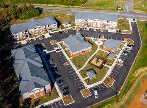 Gastonia apartment for rent - A large parking lot is surrounded by apartment buildings.