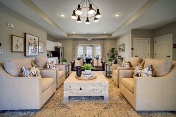 Charlotte apartment for rent - A living room with beige couches and a wooden coffee table.