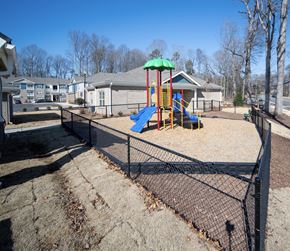 Charlotte apartment for rent - A playground with a blue slide and a green canopy.