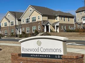 Charlotte apartment for rent - a sign in front of a row of apartment buildings