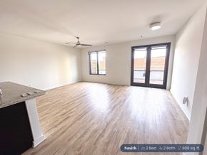 Spartanburg apartment for rent - A spacious room with a ceiling fan and a large window.